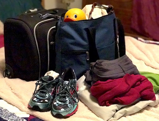 Pack it up! Rolling carry-on, tote bag, running shoes and outfit to wear on the plane. 